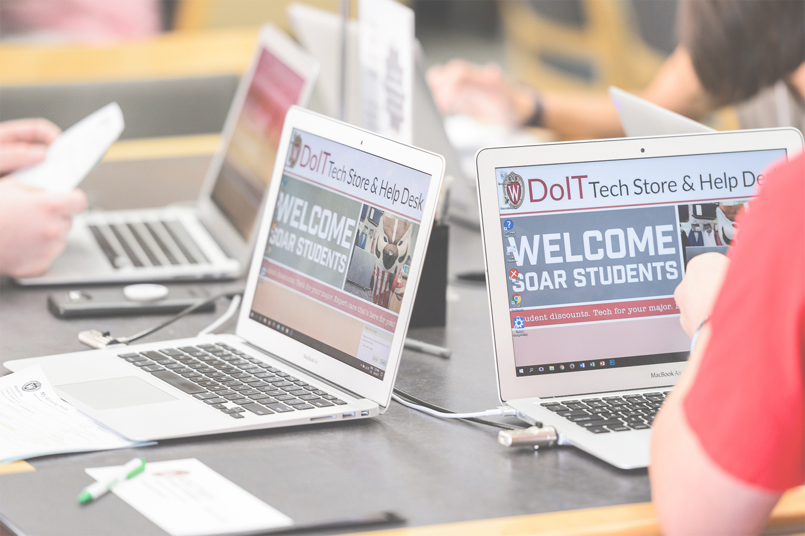 Laptop computers display the Division of Information Technology at UW-Madison logo.
