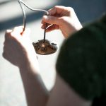An instructor rings a chime during a mindfulness meditation exercise