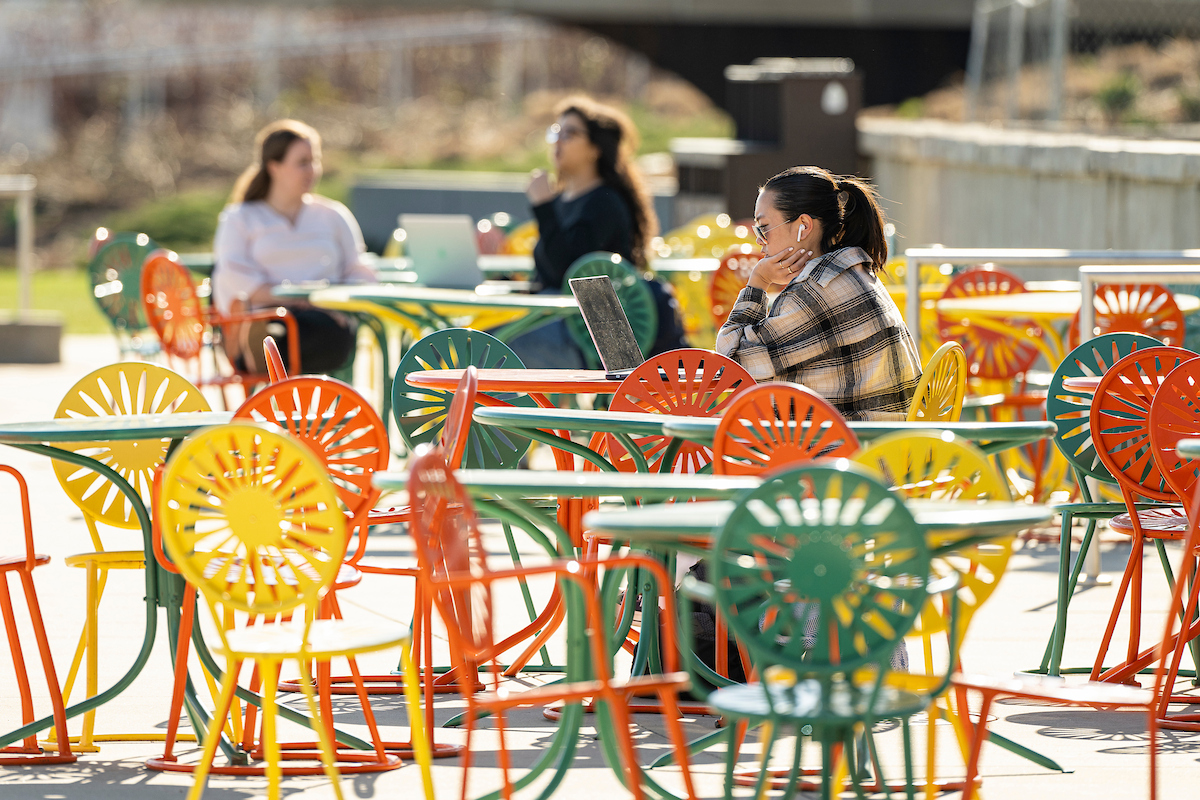 The iconic yellow, orange, and green sunburst chairs at the Memorial Union Terrace.